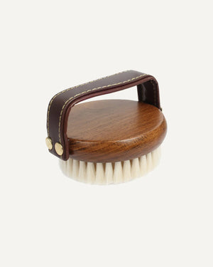 Wooden brush with a brown handle on a white background