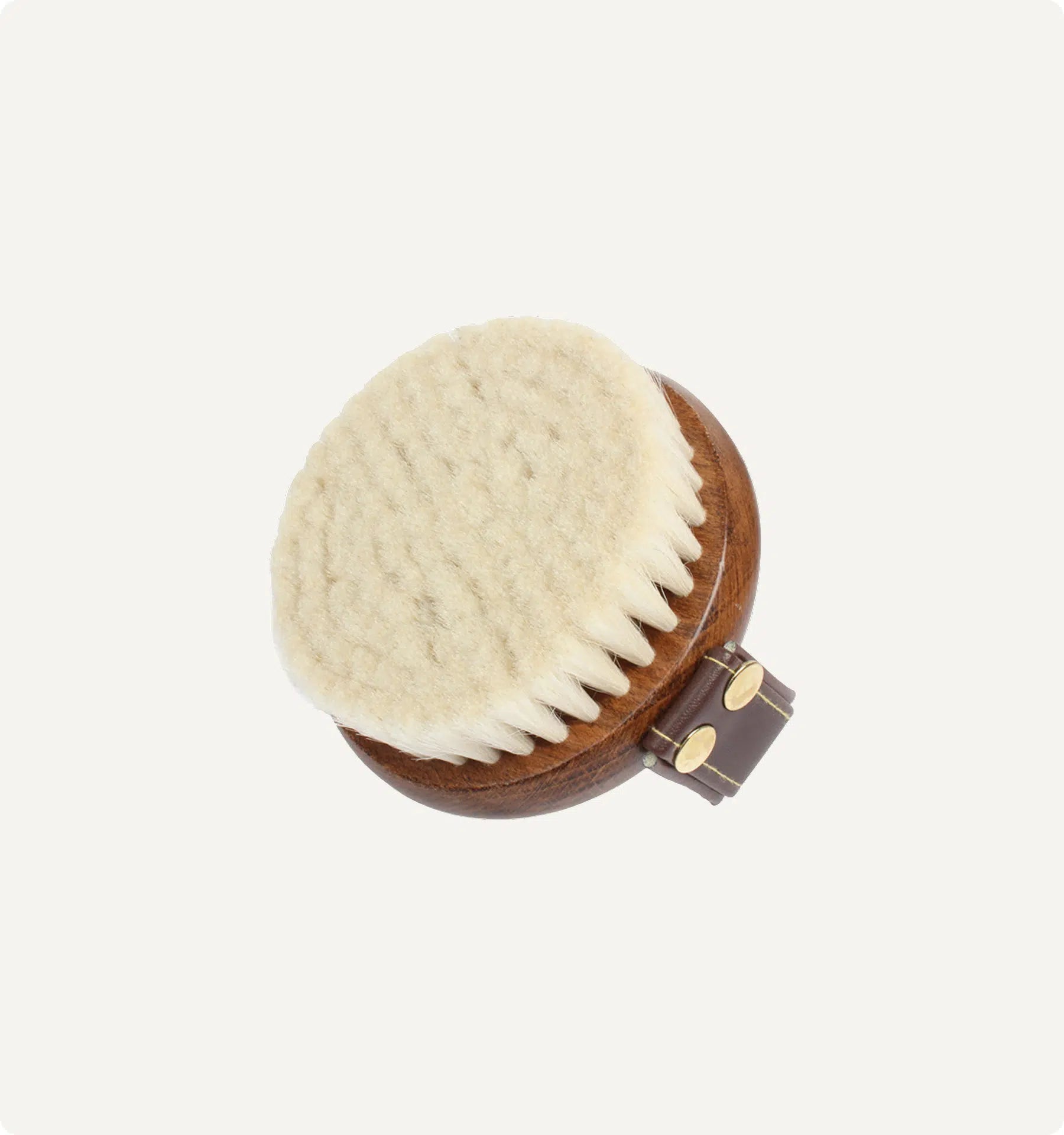 Round wooden brush with natural bristles on a white background